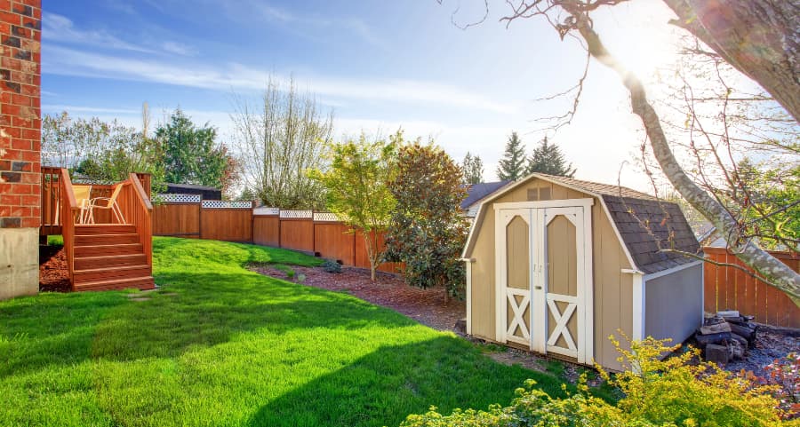 Fenced backyard with storage shed in Kansas City